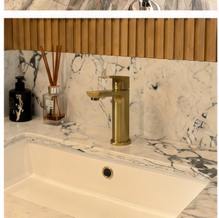 Modern bathroom fixtures including a water-efficient showerhead and dual-flush toilet in a Durban renovation