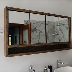 Bathroom mirror beside a natural stone wall