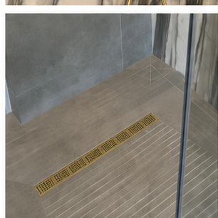 Shower floor and linear drain prepared for a bathroom renovation