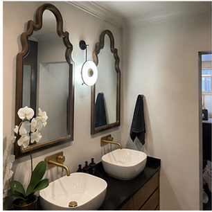 Decorative shaped mirrors above a double bathroom vanity