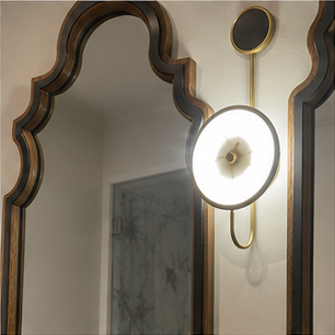 Illuminated bathroom mirror detail above a vanity