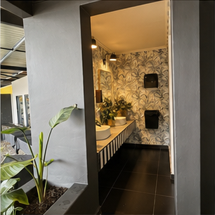 Decorative botanical bathroom wall surface used in a powder-room setting