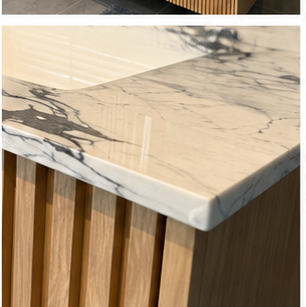 Finished stone-style vanity edge detail in a bathroom