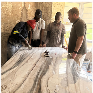 Stone fabrication team preparing a large slab for a bathroom project