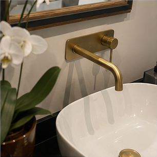 Wall mounted basin mixer below a bathroom mirror